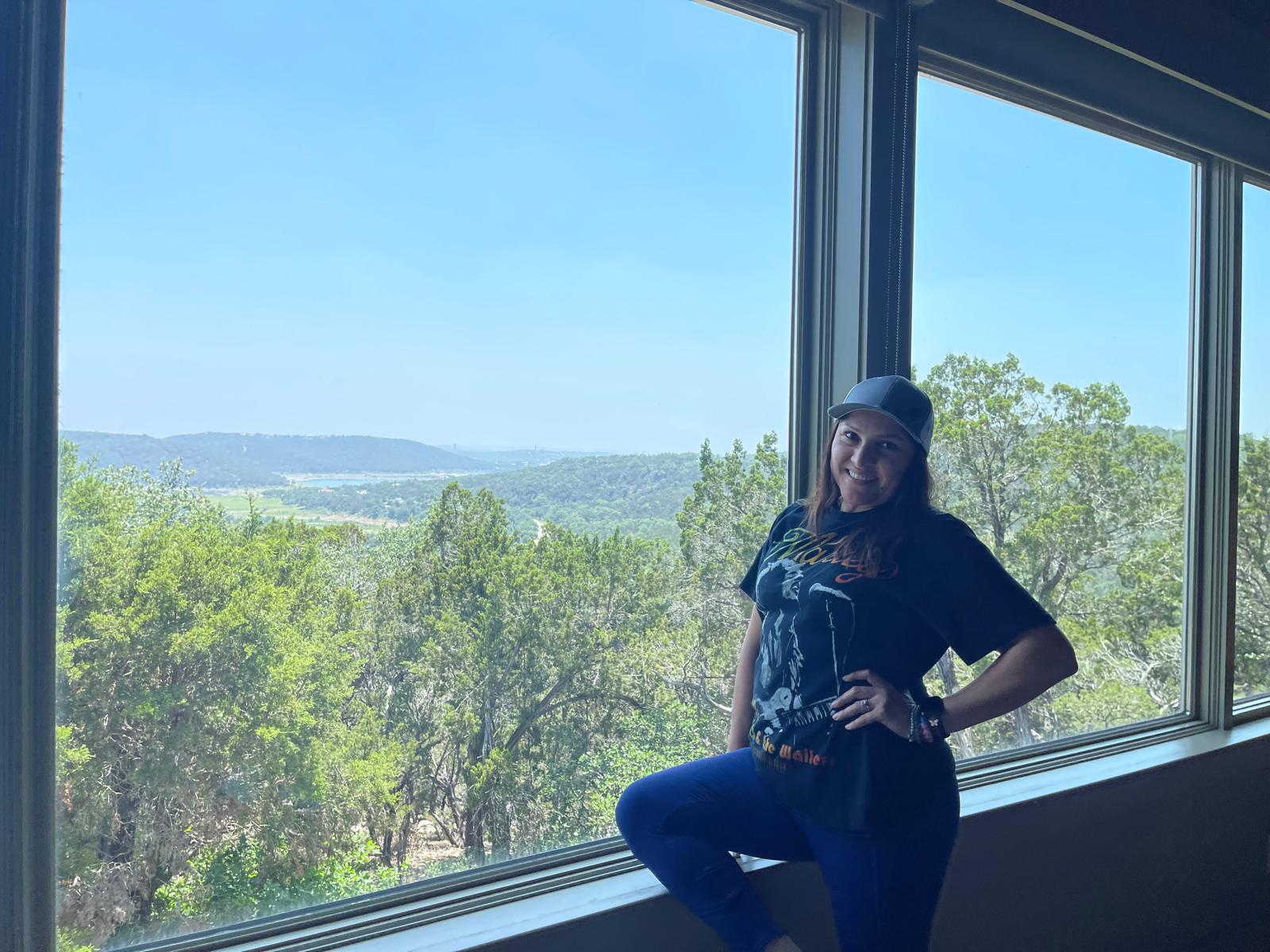 Regina posing near a window