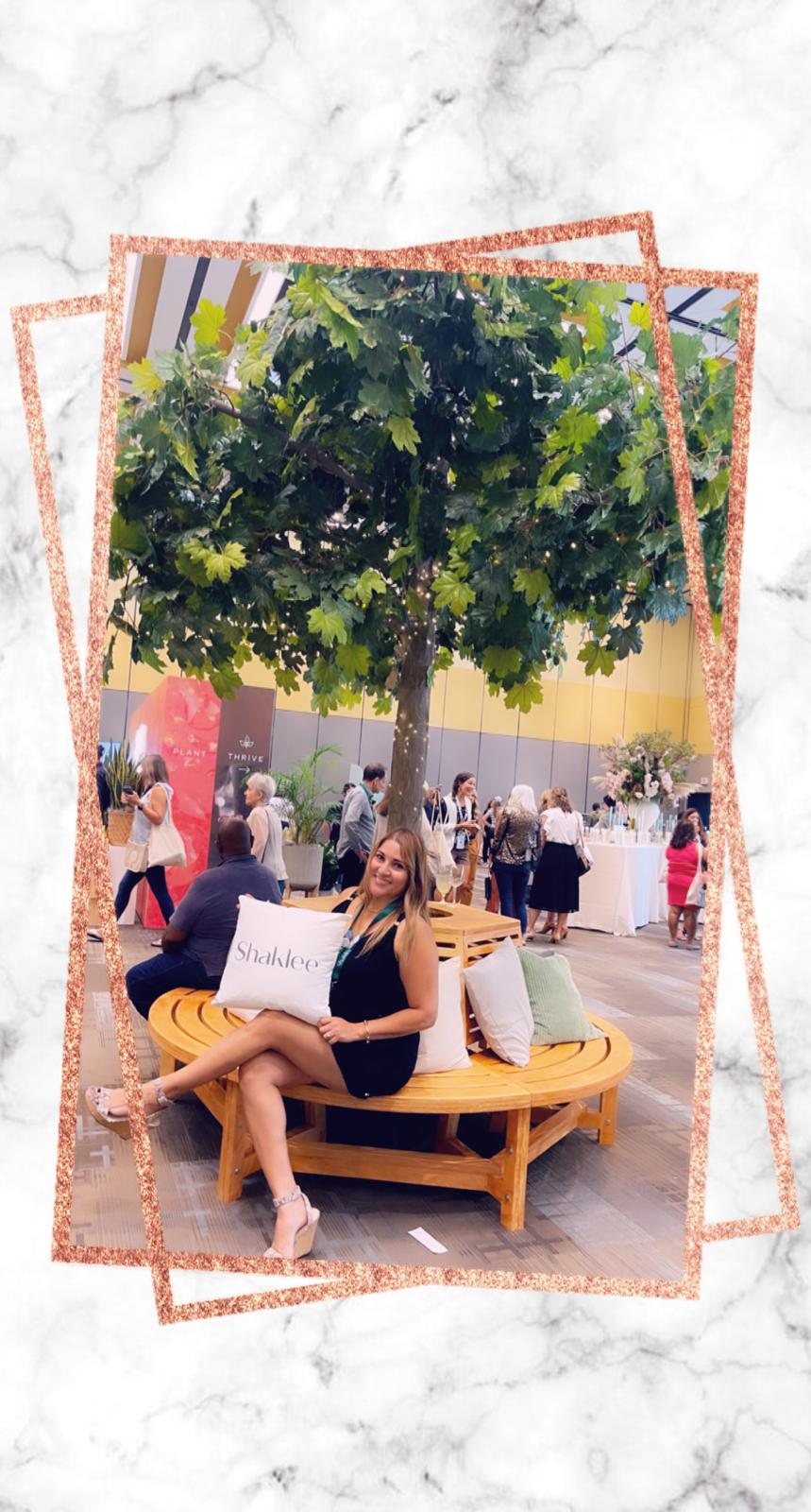 Regina posing under a small tree