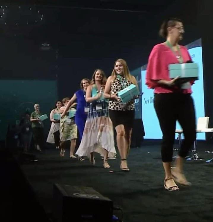 Shaklee team members walking across stage